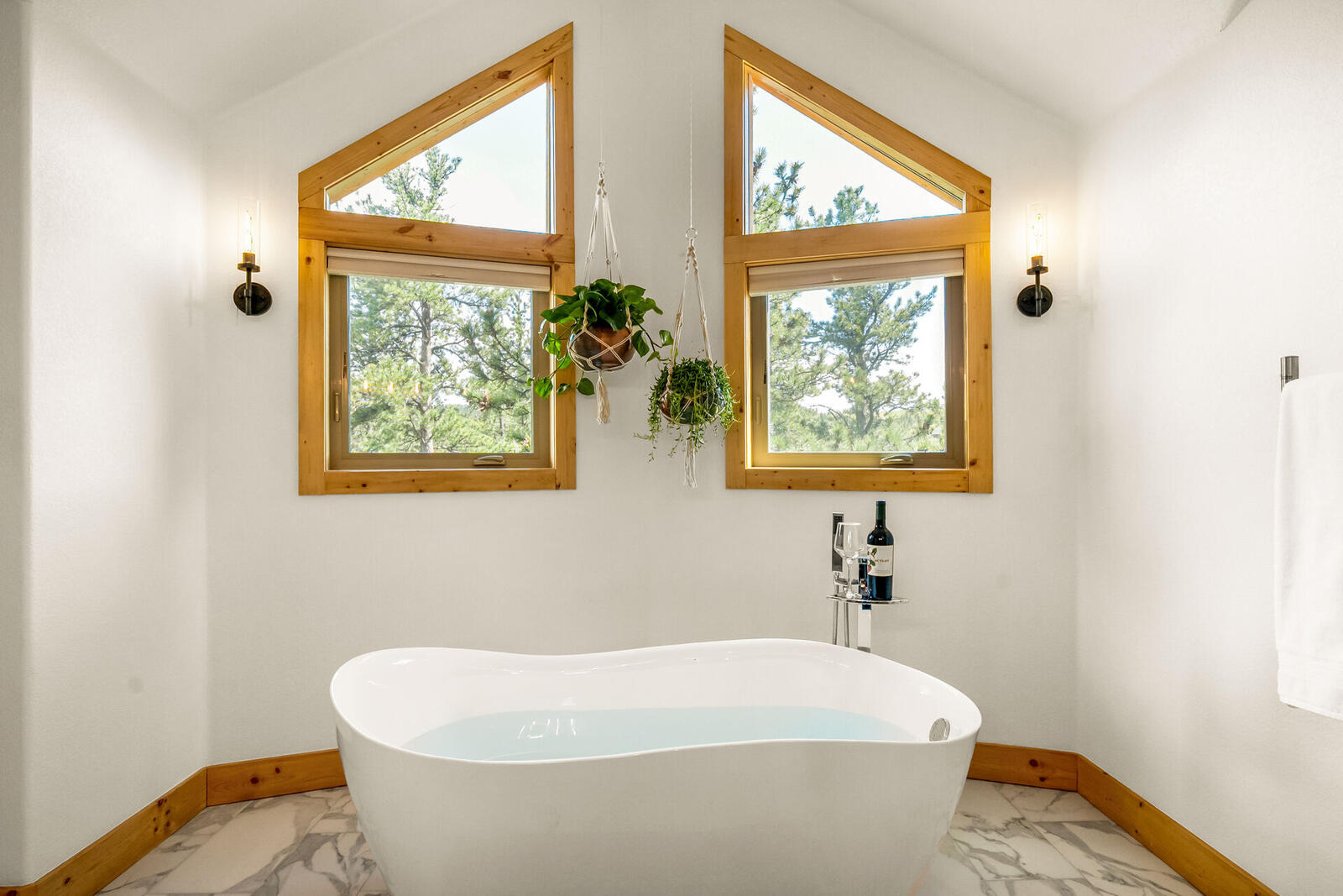 Primary bath soaking tub beneath A-frame windows